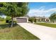 Long driveway leading to a well-maintained home with green lawns and mature trees at 3295 Bailey Ann Dr, Ormond Beach, FL 32174