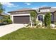 Charming home featuring a landscaped front yard, a neutral color palette, and a two-car garage at 3295 Bailey Ann Dr, Ormond Beach, FL 32174