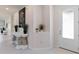 Bright foyer showcasing a decorative console table with plants, a striking art piece, and a glimpse into the home's interior at 3295 Bailey Ann Dr, Ormond Beach, FL 32174