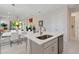 Open-concept kitchen with an island, seamlessly flowing into the dining and living areas for easy entertaining at 3295 Bailey Ann Dr, Ormond Beach, FL 32174