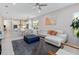 Bright living room with a white sectional sofa, gray rug, and seamless access to the kitchen and dining areas at 3295 Bailey Ann Dr, Ormond Beach, FL 32174