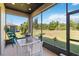 Covered patio overlooking a beautifully landscaped yard and a lush wooded area at 3295 Bailey Ann Dr, Ormond Beach, FL 32174