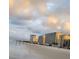 Picturesque ocean view of a sandy beach meeting tall condominium buildings under a beautiful cloudy sky at 3799 S Atlantic Ave # 1006, Daytona Beach, FL 32118