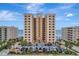 Beautiful exterior view of the beachfront condo building with palm trees and ample parking at 3799 S Atlantic Ave # 1006, Daytona Beach, FL 32118