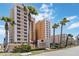 Sanibel Condominiums property residential complex with mature palm tree landscaping at 3799 S Atlantic Ave # 1006, Daytona Beach, FL 32118