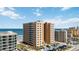 Stunning aerial view of a beachfront condo building featuring a well-manicured lawn and beachfront access at 3799 S Atlantic Ave # 1006, Daytona Beach, FL 32118