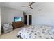 Bright main bedroom featuring a ceiling fan, large dresser, and ample space at 3799 S Atlantic Ave # 1006, Daytona Beach, FL 32118