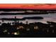 Scenic night view of islands and illuminated houses reflecting on the calm waters under a colorful sky at 3799 S Atlantic Ave # 1006, Daytona Beach, FL 32118
