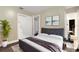 Serene bedroom featuring a bed, bedside table, closet, and modern artwork at 4108 Drexel Ave, Orlando, FL 32808