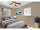 Inviting bedroom featuring a comfortable bed, ceiling fan, and natural light from the windows at 4108 Drexel Ave, Orlando, FL 32808