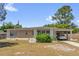 Charming single-story home featuring stone accents, a covered carport, and a well-maintained front yard at 4108 Drexel Ave, Orlando, FL 32808