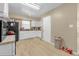 Bright kitchen featuring white cabinets, black appliances, and a window above the sink at 4108 Drexel Ave, Orlando, FL 32808