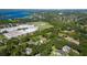 Scenic aerial view showcases a beautiful neighborhood close to a school, surrounded by lush trees and a lake at 4464 Willow Wind Ct, Orlando, FL 32835