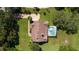 Aerial view of a single Gathering home with a screened-in pool, well-manicured lawn and brick driveway at 4464 Willow Wind Ct, Orlando, FL 32835