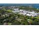 Breathtaking aerial view of a neighborhood surrounded by lush trees, a school, and serene lakes at 4464 Willow Wind Ct, Orlando, FL 32835