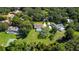 Expansive aerial view showcases a charming neighborhood with lush landscaping, sparkling pools, and mature trees at 4464 Willow Wind Ct, Orlando, FL 32835