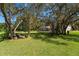 Backyard view of screened-in pool, seating area, and lush landscaping at 4464 Willow Wind Ct, Orlando, FL 32835