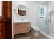 Bathroom featuring wood cabinet, white countertop, white toilet, and glass enclosed shower at 4464 Willow Wind Ct, Orlando, FL 32835