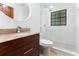 Bathroom featuring a granite countertop, oval mirror, and glass shower with tiled walls and shower floor at 4464 Willow Wind Ct, Orlando, FL 32835