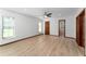 Bright bedroom with wood-look floors, ceiling fan, and access to an en-suite bathroom at 4464 Willow Wind Ct, Orlando, FL 32835