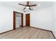 Bedroom featuring a ceiling fan, wood-look floors, a window, and a closet at 4464 Willow Wind Ct, Orlando, FL 32835