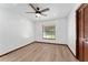 Bedroom featuring a ceiling fan, wood-look floors, and a window with blinds at 4464 Willow Wind Ct, Orlando, FL 32835