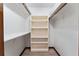 Walk-in closet with wood trim, shelving, hanging rods, and wood-look floors at 4464 Willow Wind Ct, Orlando, FL 32835