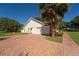 Image shows a 2 car garage and paved driveway with landscaping at 4464 Willow Wind Ct, Orlando, FL 32835