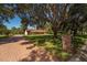View of house featuring long driveway leading to the house, mature landscaping and manicured front lawn at 4464 Willow Wind Ct, Orlando, FL 32835