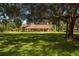 Traditional style home with large front yard, large trees, and manicured landscaping at 4464 Willow Wind Ct, Orlando, FL 32835