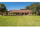 Charming brick home with a well-manicured lawn, lush landscaping, and beautiful curb appeal on a sunny day at 4464 Willow Wind Ct, Orlando, FL 32835