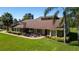 A brick home featuring a well-manicured lawn, vibrant landscaping, and a welcoming brick walkway on a sunny day at 4464 Willow Wind Ct, Orlando, FL 32835