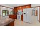 Kitchen featuring updated appliances, granite counters, and wood cabinetry at 4464 Willow Wind Ct, Orlando, FL 32835