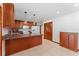 Cozy kitchen with granite countertops, wood cabinets, and modern lighting at 4464 Willow Wind Ct, Orlando, FL 32835