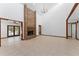 Spacious living room boasting a floor-to-ceiling brick fireplace, tile flooring, and high ceilings at 4464 Willow Wind Ct, Orlando, FL 32835