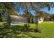 Enclosed swimming pool with green lawn and landscaping at 4464 Willow Wind Ct, Orlando, FL 32835