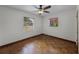 Inviting bedroom with hardwood floors, natural lighting from two windows, offering warmth and comfort at 4816 Davisson Ave, Orlando, FL 32804