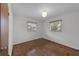 Cozy bedroom featuring hardwood floors, natural lighting, and a closet for sufficient storage at 4816 Davisson Ave, Orlando, FL 32804