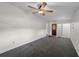 A minimalist bedroom with light-colored walls and carpet, enhanced by natural light from the windows at 4816 Davisson Ave, Orlando, FL 32804
