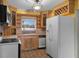 Well-lit kitchen with wooden cabinets and backsplash, featuring a window above the sink at 4816 Davisson Ave, Orlando, FL 32804