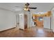 Spacious room with wooden flooring, a ceiling fan, and a kitchen view for easy serving at 4816 Davisson Ave, Orlando, FL 32804