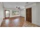 Bright living room boasts hardwood floors, a ceiling fan, and natural light from a large window and glass door at 4816 Davisson Ave, Orlando, FL 32804