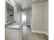 Bright bathroom features a wood plank ceiling, granite countertops, and a frameless shower at 5037 Bermuda Cir # 10, Orlando, FL 32808