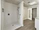 Modern tiled shower with open access to vanity area and sliding barn door at 5037 Bermuda Cir # 10, Orlando, FL 32808