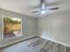 Clean bedroom featuring wood-look floors, neutral walls, and a large window at 5037 Bermuda Cir # 10, Orlando, FL 32808
