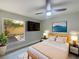 Cozy bedroom featuring wood-look floors, a ceiling fan, and a large window at 5037 Bermuda Cir # 10, Orlando, FL 32808