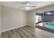 Inviting bedroom with sliding doors leading to pool, fan, and wood floors at 5037 Bermuda Cir # 10, Orlando, FL 32808