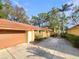 Property with a terracotta roof, a paved driveway, and a two-car garage at 5037 Bermuda Cir # 10, Orlando, FL 32808
