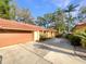 Property with a terracotta roof, a paved driveway, and a two-car garage at 5037 Bermuda Cir # 10, Orlando, FL 32808