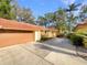 Property with a terracotta roof, a paved driveway, and a two-car garage at 5037 Bermuda Cir # 10, Orlando, FL 32808